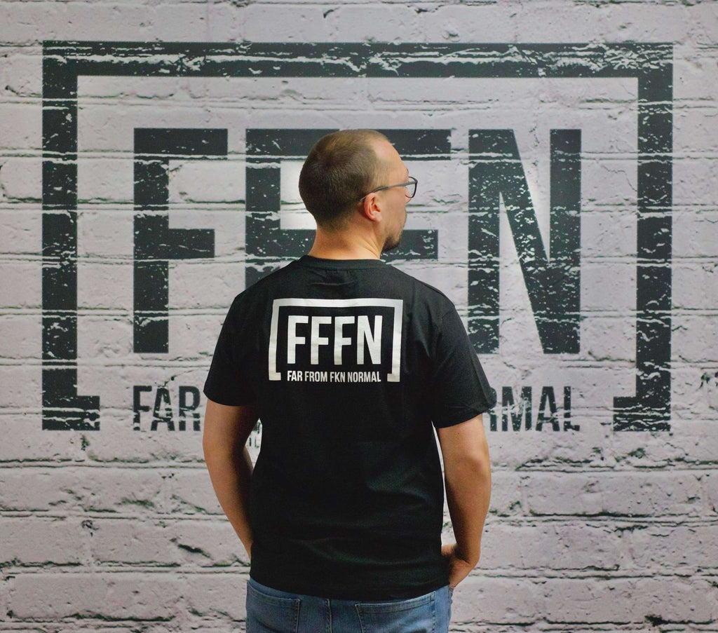 Black Unisex Rear Logo T-Shirt on model [model:none]