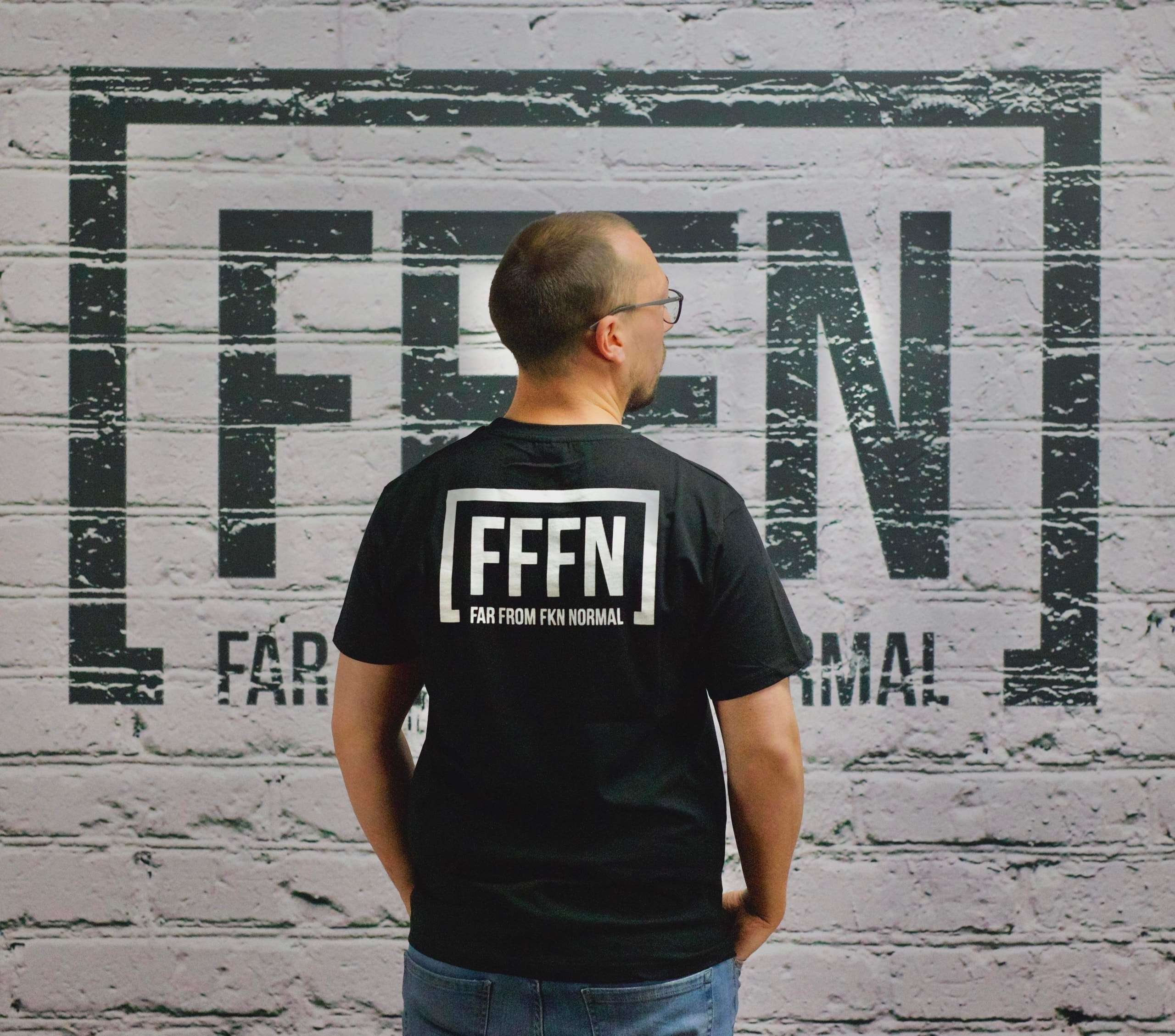 Black Unisex Rear Logo T-Shirt on model